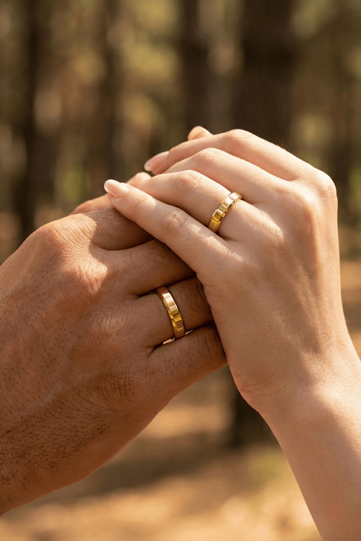 14 Ayar Altın 4 mm Kesme Alyans takan çiftlerin elleri, doğal bir ortamda buluşuyor.